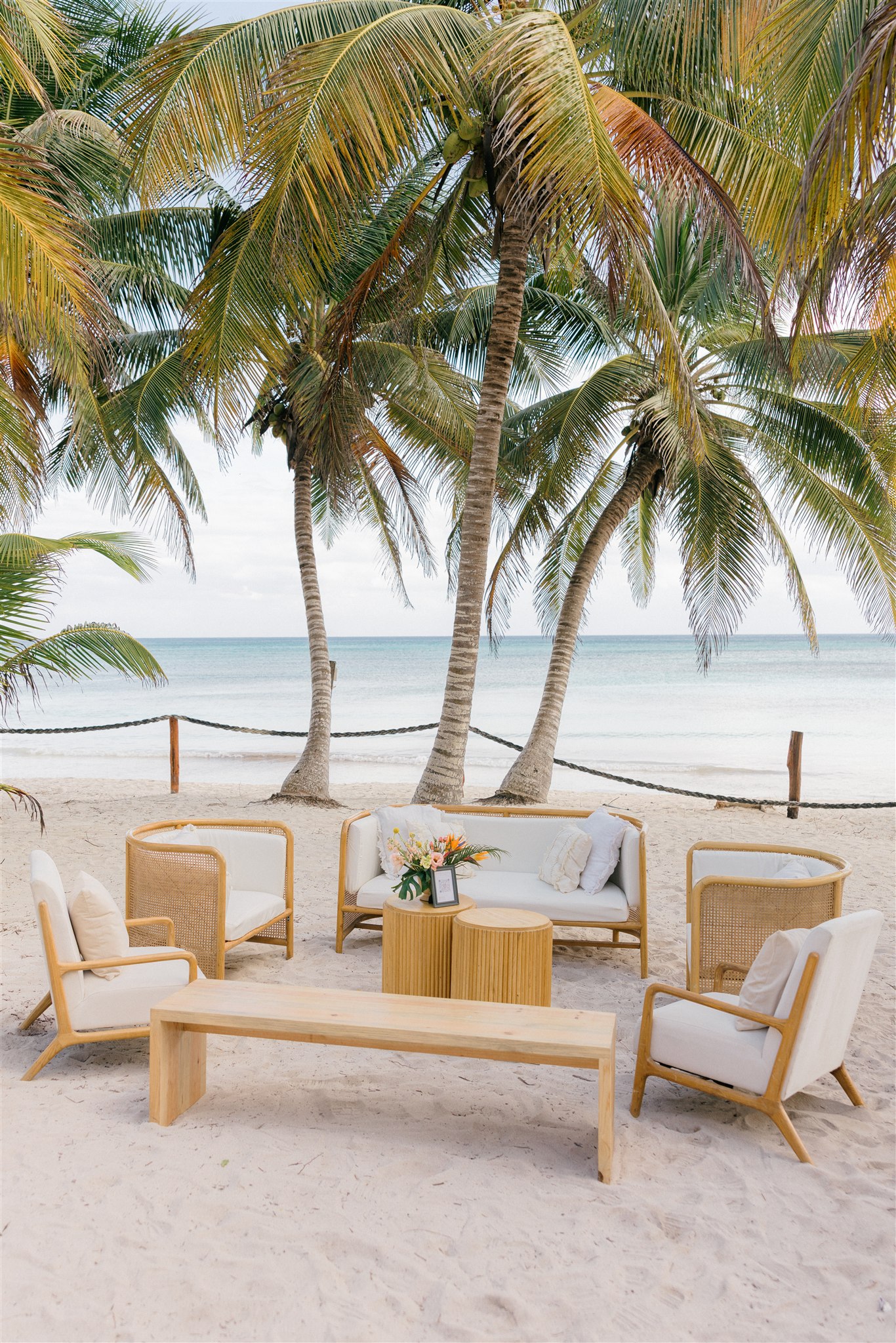Wedding lounge setup under palm trees, Riviera Maya beach wedding venue