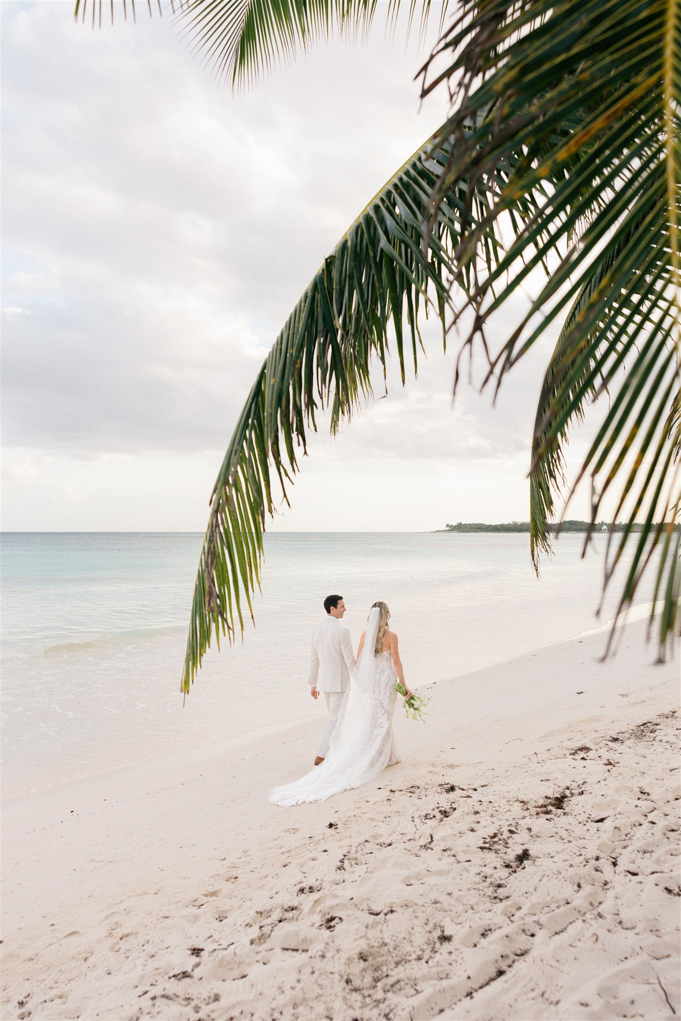 Distant portrait of bride on the Caribbean shoreline, Saasil Kantenah