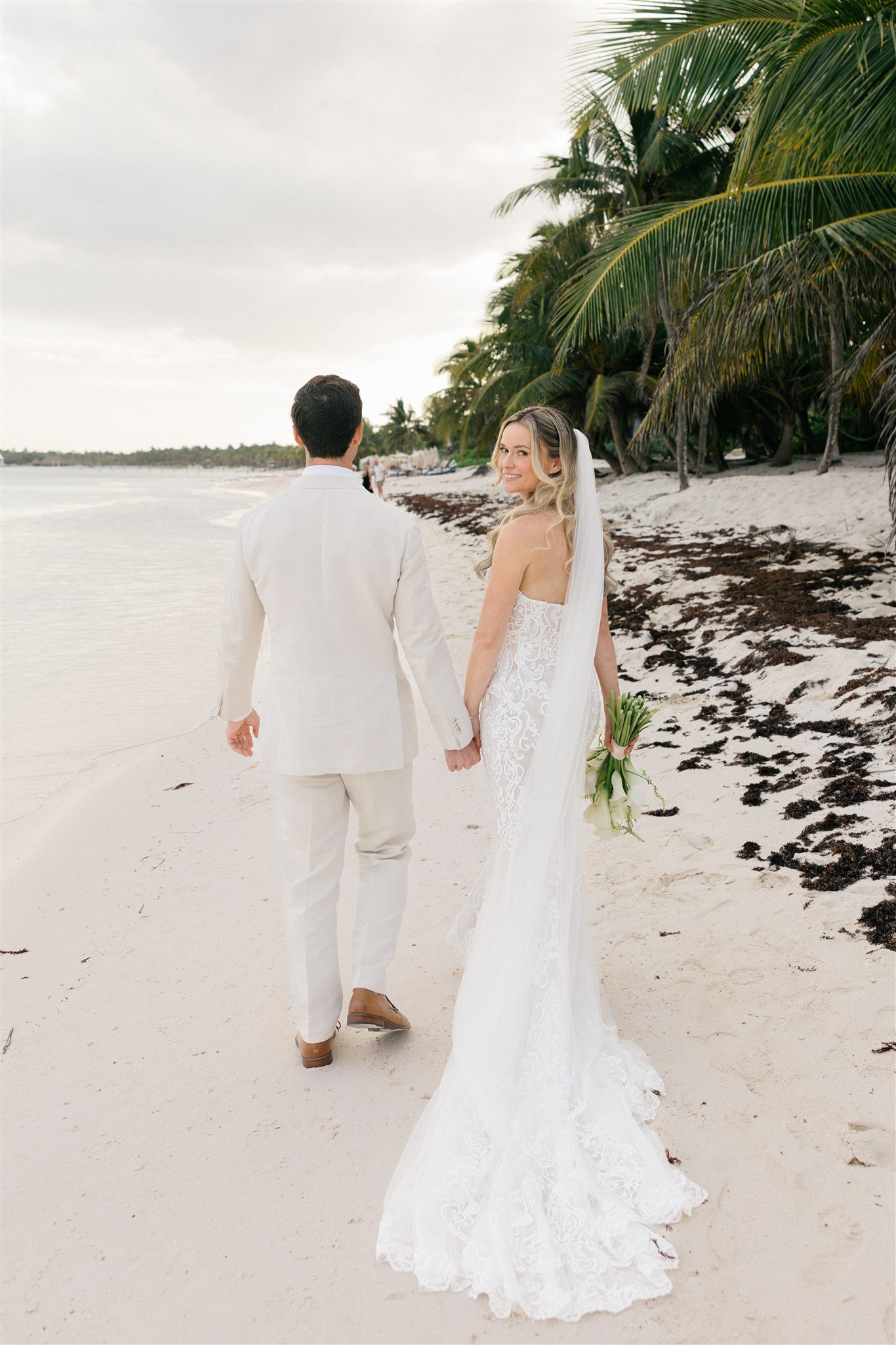 Couple walking away along the shore, Riviera Maya wedding photographer