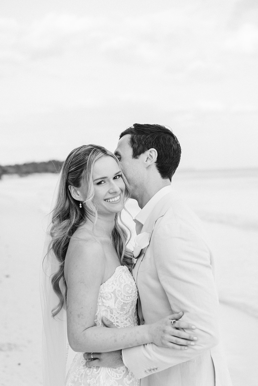 Bride and groom embrace on the beach at Saasil Kantenah, Riviera Maya wedding photographer