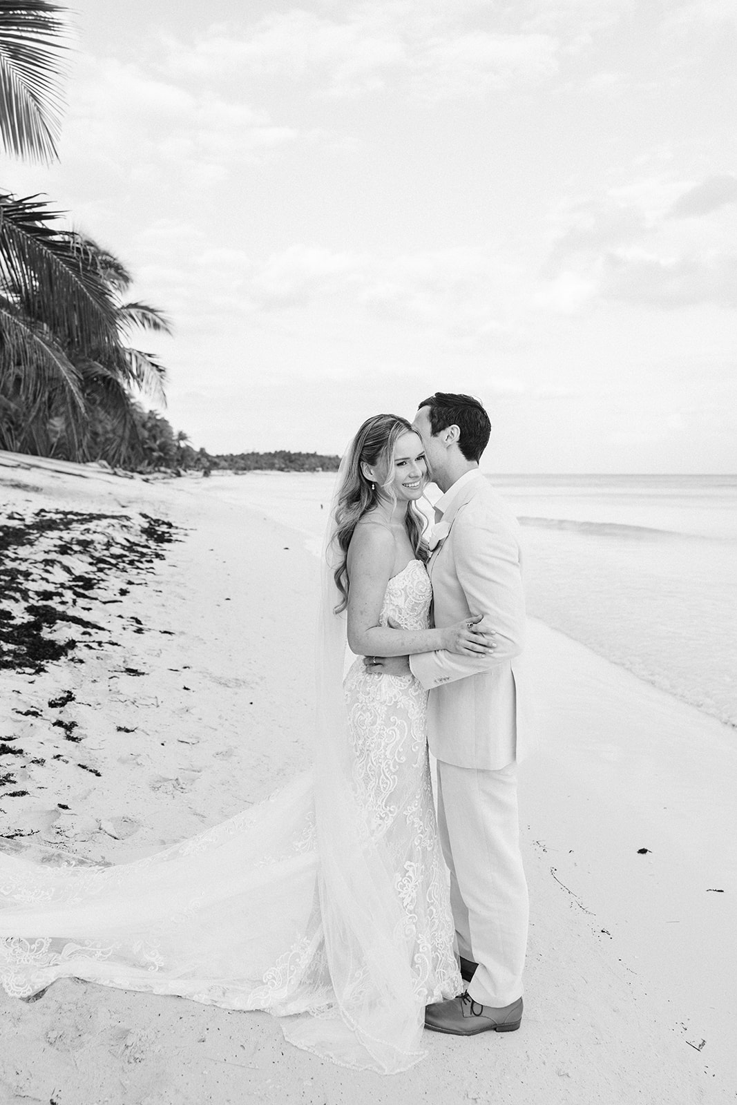 Bride and groom in black and white portrait on the beach, Riviera Maya