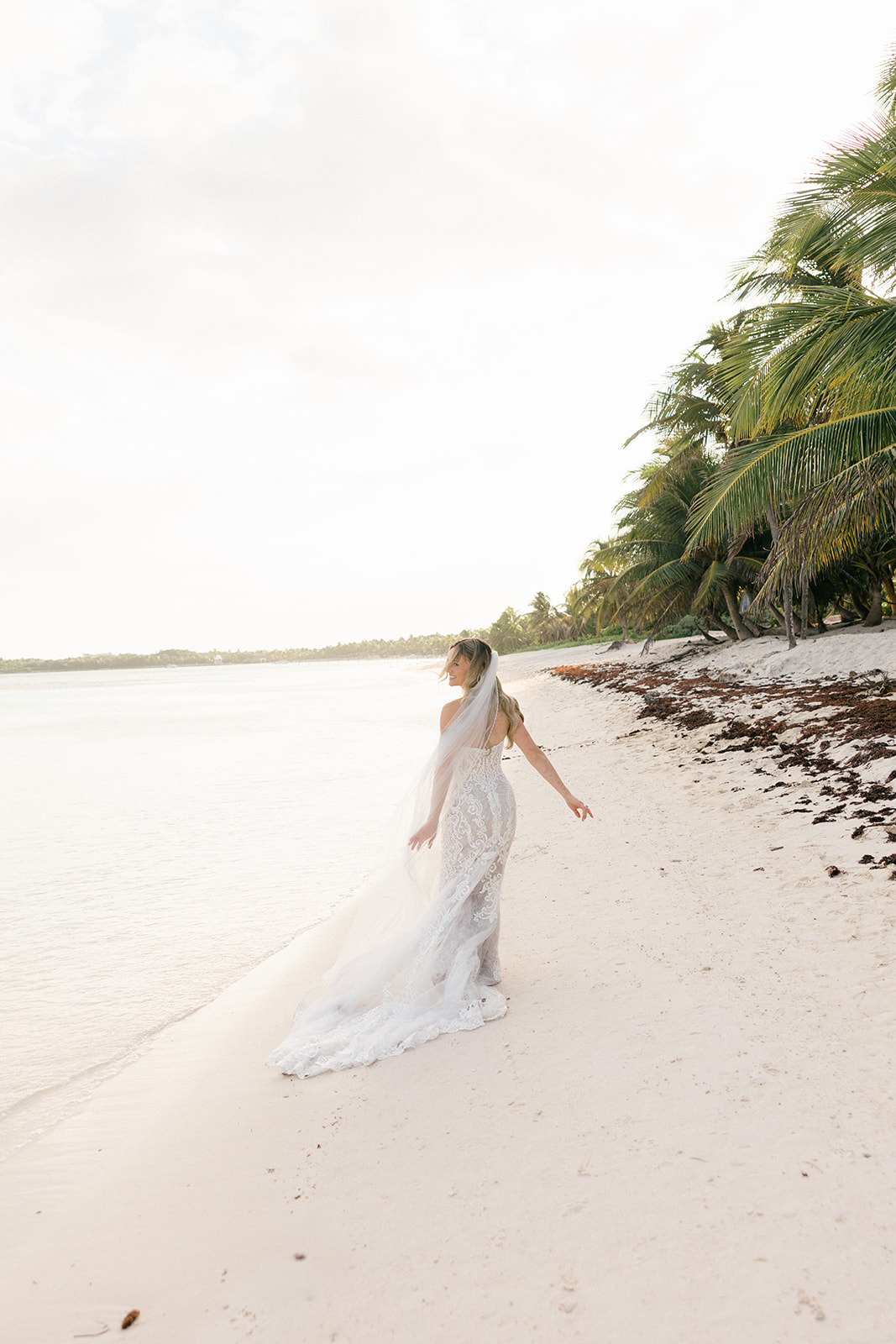 Bride smiling during beach portraits, Riviera Maya wedding photographer