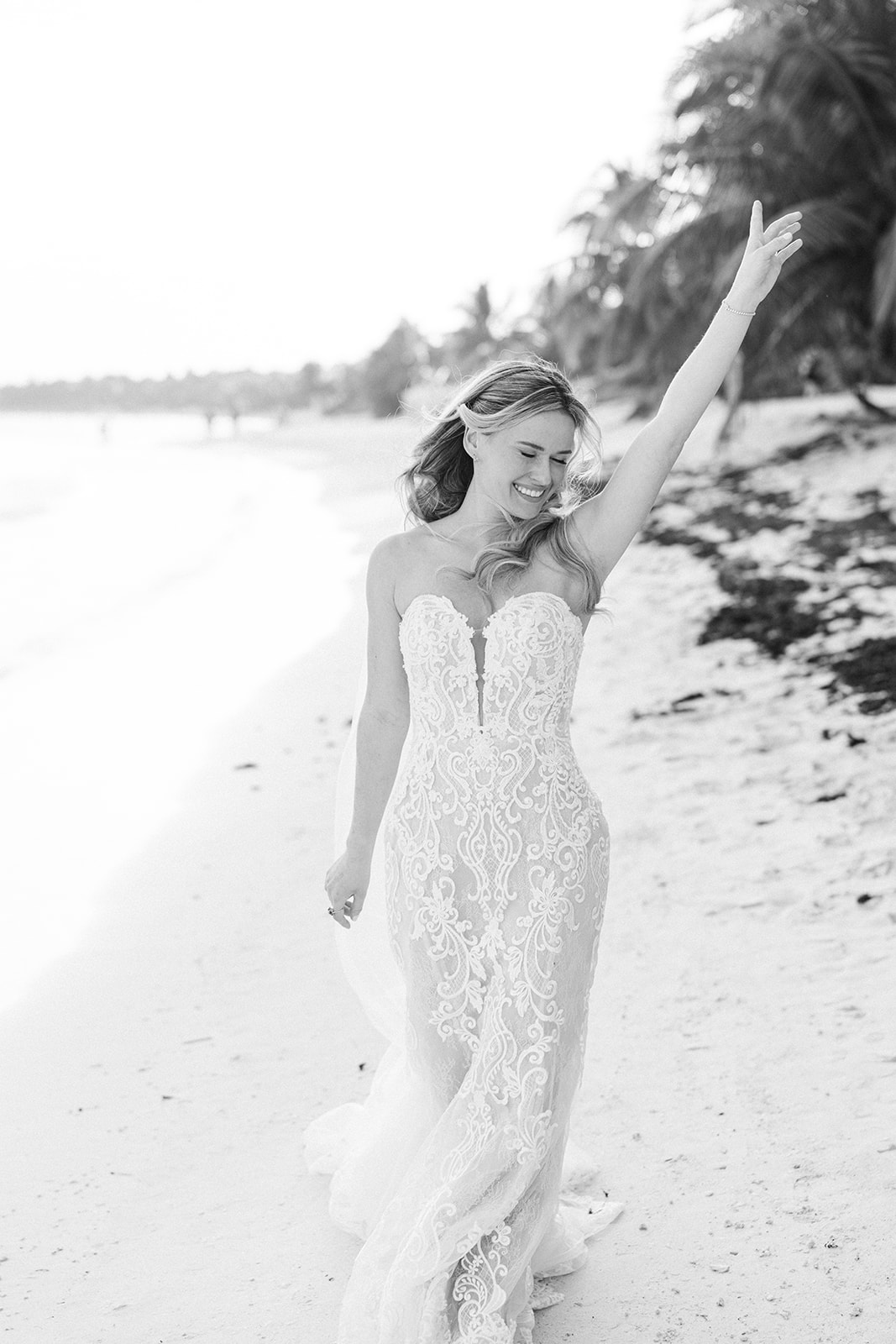 Bride in lace gown dancing on the beach, Saasil Kantenah wedding