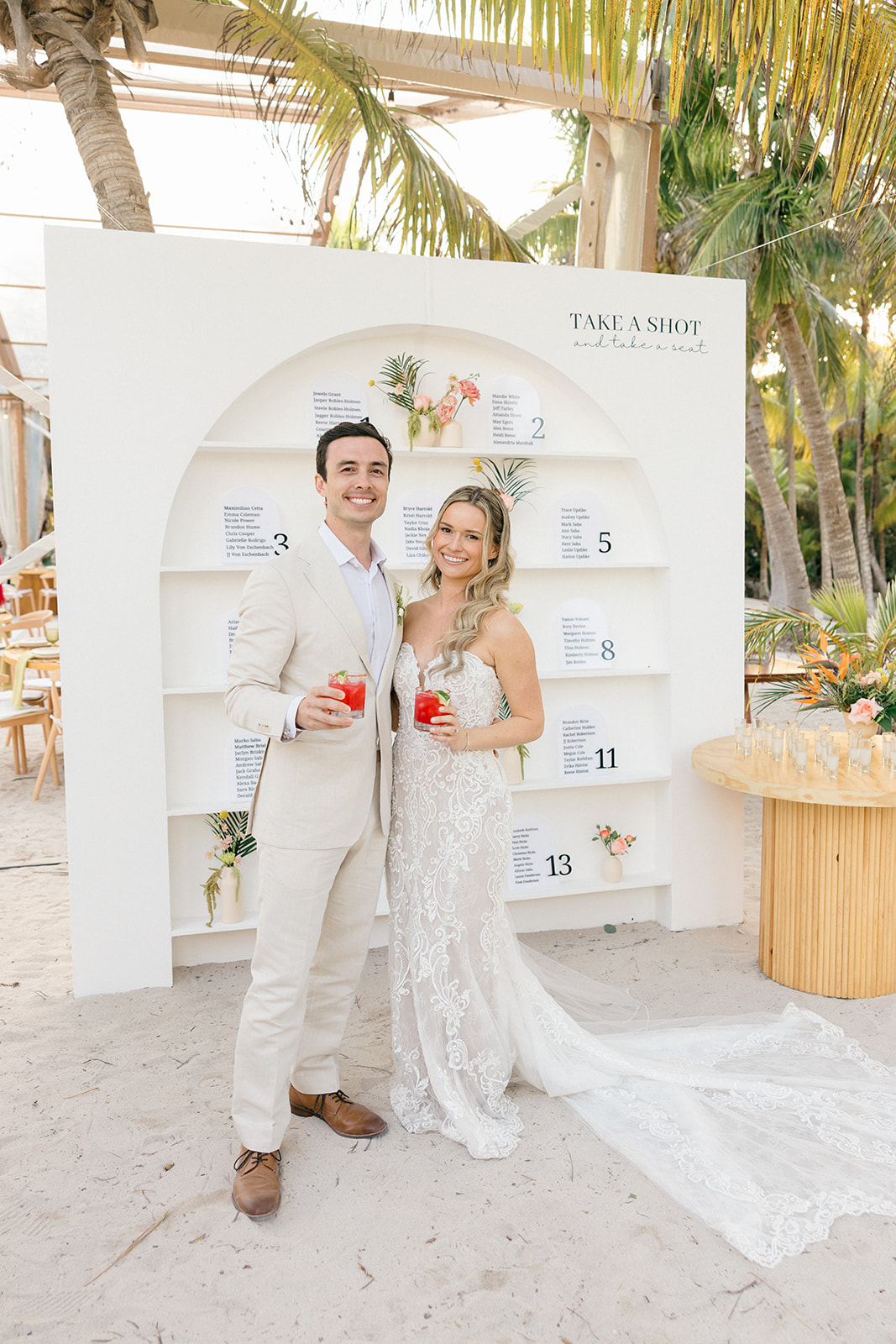 Couple at the seating chart display, Riviera Maya beach wedding
